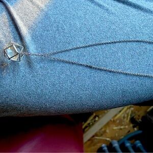 Silver necklace with unique style ball with gem inside